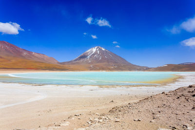 Scenic view of beach against blue sky