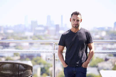 An outdoor portrait of a man with a city view.