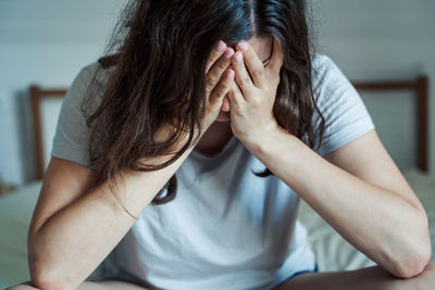 Midsection of woman sitting at home