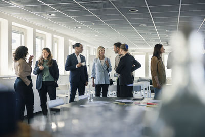 Group of business people talking during conference break