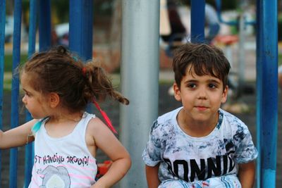 Siblings sitting outdoors