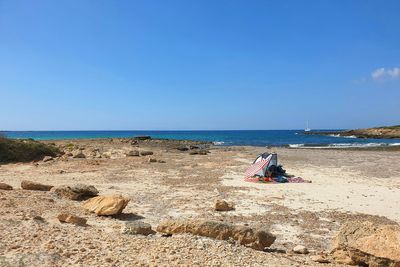 Stillife with sole blanket and sunshade on stoney part of es trenc beach