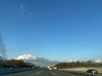 Road against sky seen through windshield