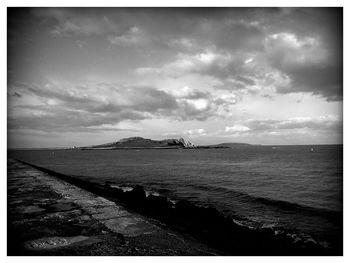 Scenic view of sea against cloudy sky