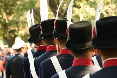 Rear view of people standing outdoors