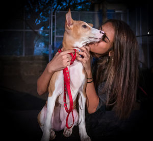 Portrait of woman holding dog