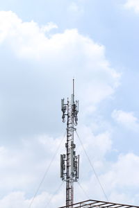 Low angle view of communications tower against sky