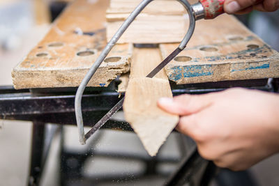 Close-up of man working on wood