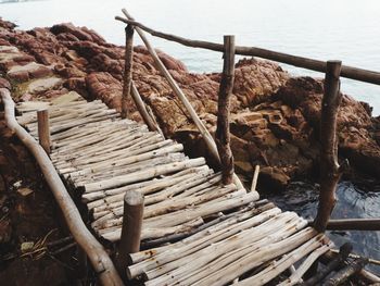 High angle view of wooden logs on beach