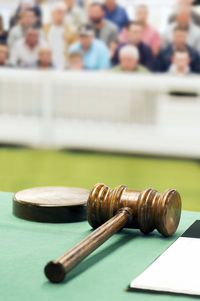 Close-up of gavel on table