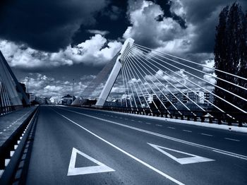 Empty road against cloudy sky