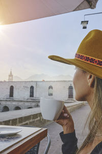 Tourist woman drinking coffee on vacation in street, arequipa, peru. selective focus