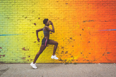 Full length of man against yellow wall