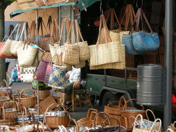 Bags and wicker baskets at market for sale