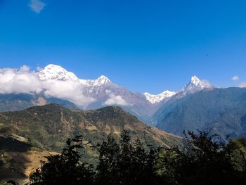 Scenic view of mountains against clear blue sky