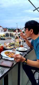 Side view of man preparing food at restaurant