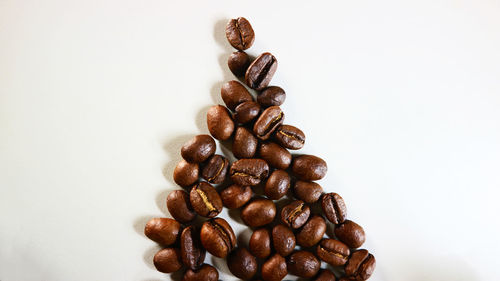 Close-up of coffee beans against white background