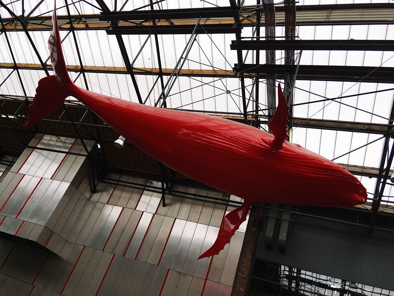 LOW ANGLE VIEW OF RED CEILING IN FACTORY