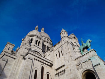 Low angle view of statue against blue sky