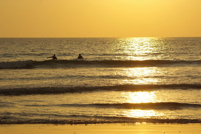 Scenic view of sea against orange sky