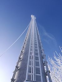 Low angle view of tower against blue sky