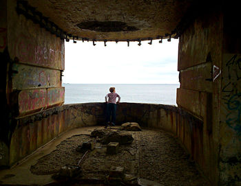 Rear view of woman looking at sea against sky