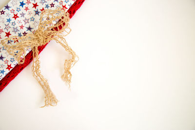 Close-up of necklace over white background