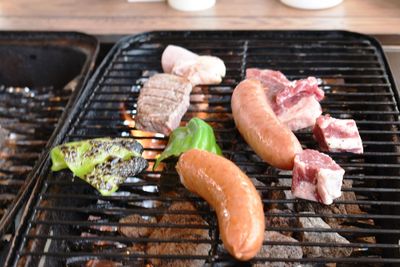 High angle view of meat on barbecue grill