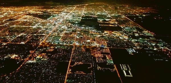 Aerial view of illuminated buildings in city at night