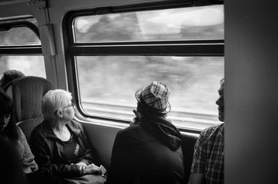 Rear view of people sitting in train