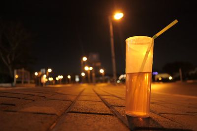 Drink in bottle on road at night