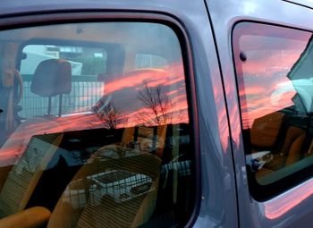 Reflection of man on car window