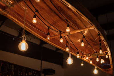 Low angle view of illuminated light hanging from ceiling