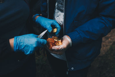 Midsection of men with mushrooms