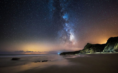 Scenic view of sea against sky at night