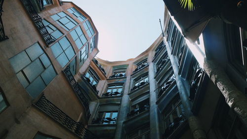 Low angle view of buildings in town against sky