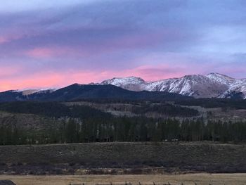 Scenic view of snowcapped mountains against sky during sunset