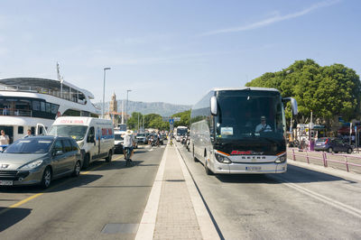 Cars on street in city against sky