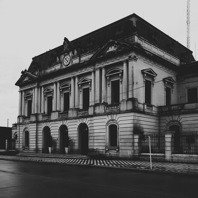 architecture, built structure, building exterior, facade, low angle view, arch, history, sky, clear sky, window, entrance, steps, old, exterior, outdoors, architectural column, building, day, travel destinations, historic