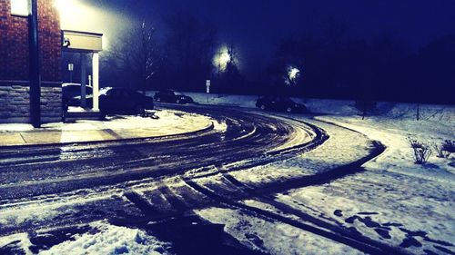 Snow covered road at night