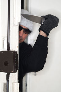 Thief with knife opening door