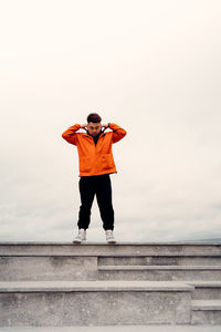 Full length of man standing against the wall