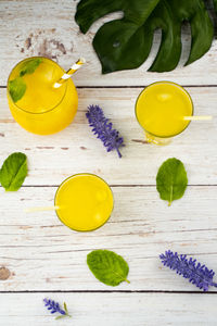 High angle view of yellow drink on table