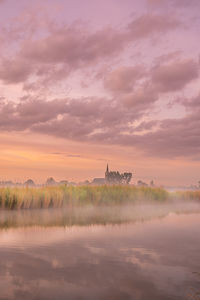 Scenic view of lake against sky during sunset