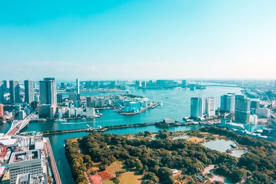 High angle view of buildings and sea against sky