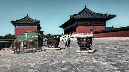 People at temple against sky