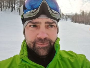 Portrait of smiling man in snow