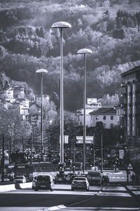 Low angle view of street light against mountains in city