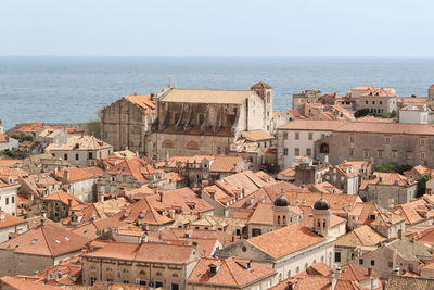 High angle view of townscape by sea against clear sky