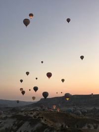 Hot air balloons flying in sky during sunset